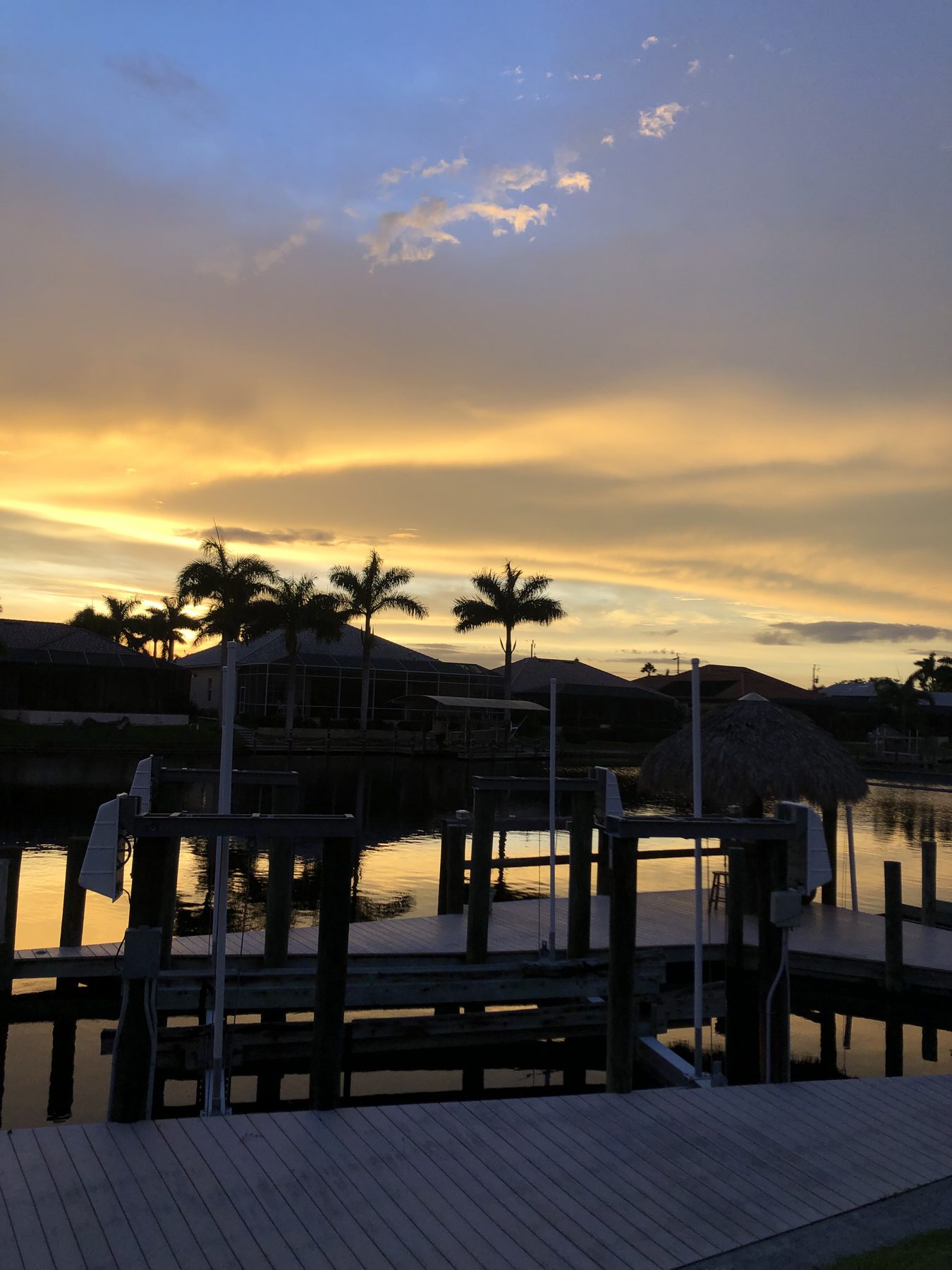 A quiet Cape Coral dock at the end of the day, water like glass